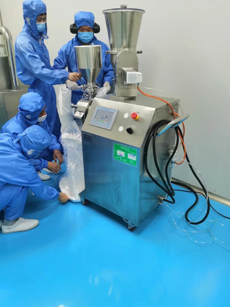 Operators feeding spinning extruder at granulation line