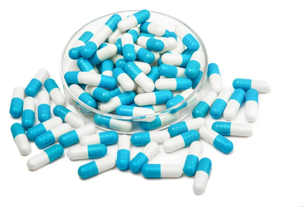 Vegetable capsules arranged on stainless steel machine tray